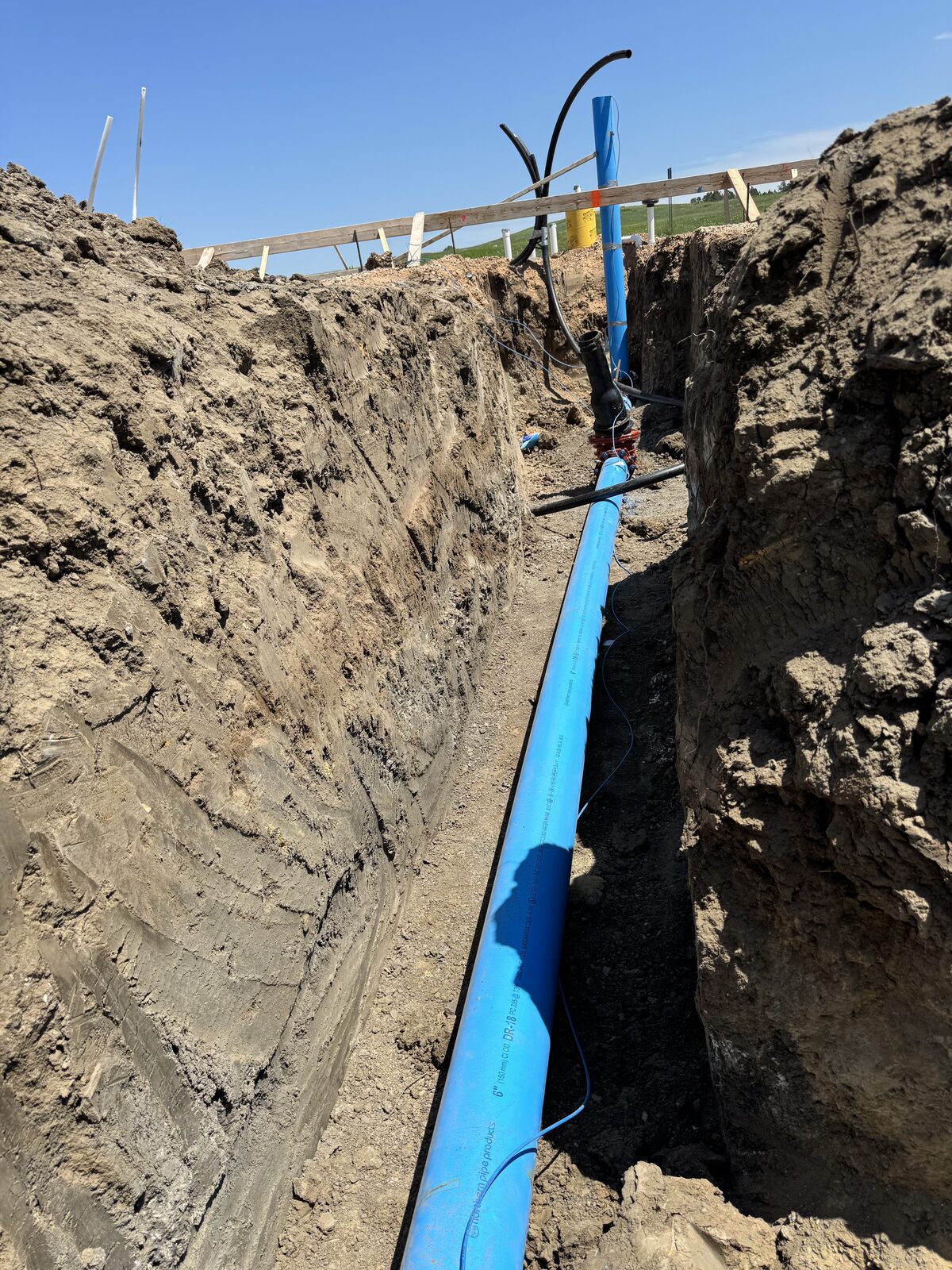 Deep trench with blue water main line